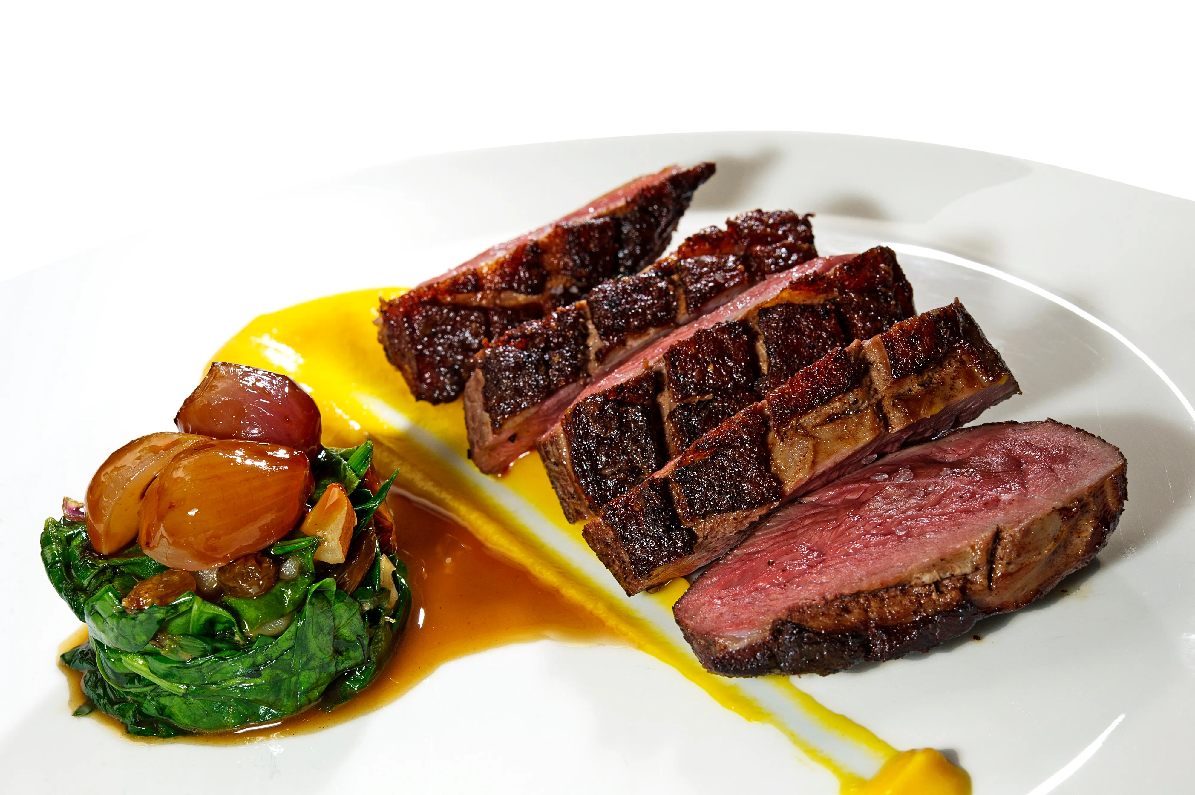 Sliced Grilled Beef Steak Saffron Sauce Sauteed Spinach Houston - Food & Product Photography in Houston Texas